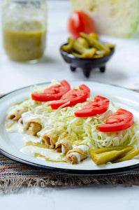 These crispy air fryer tacos tapatios are filled with seasoned soy curls, crisped to perfection, and topped with salsa verde, crema, pickled cabbage, and tomato